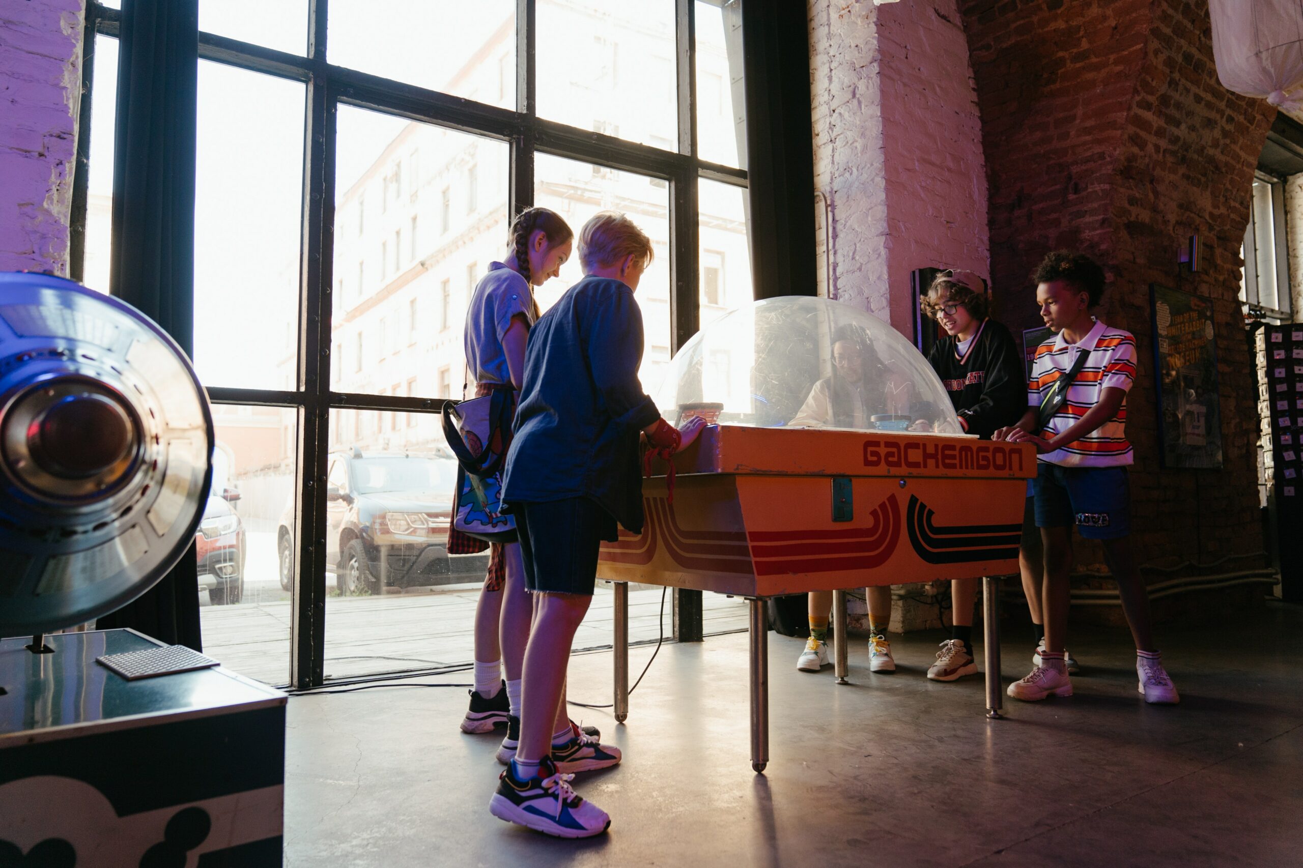 Teens playing at arcade